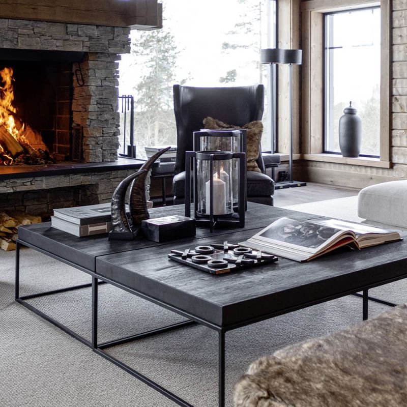 Rectangular coffee table with black metal legs and black wooden tabletop