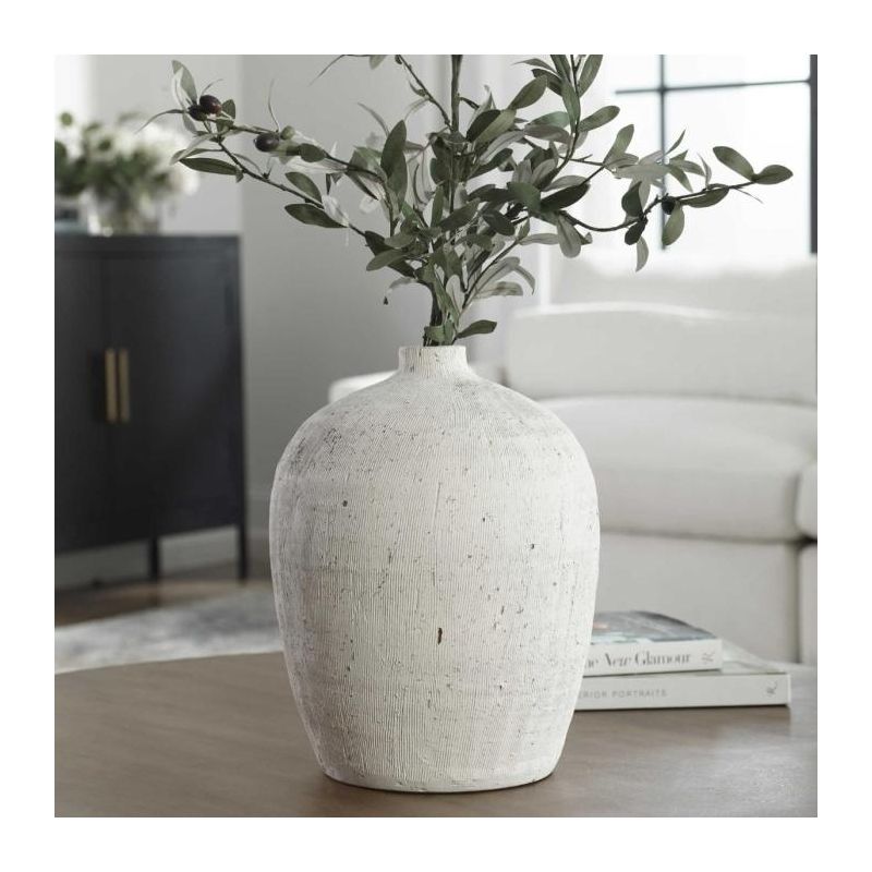 Textured ceramic vase with oval shape and small opening