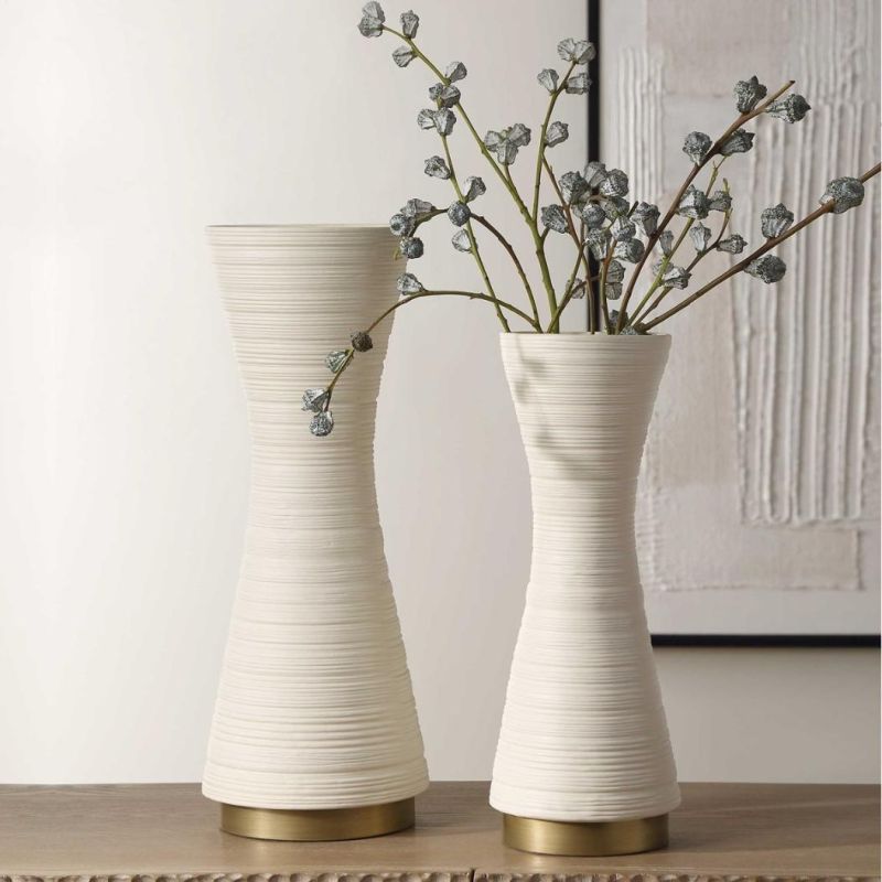 Ridged cream vases with curvaceous silhouette.