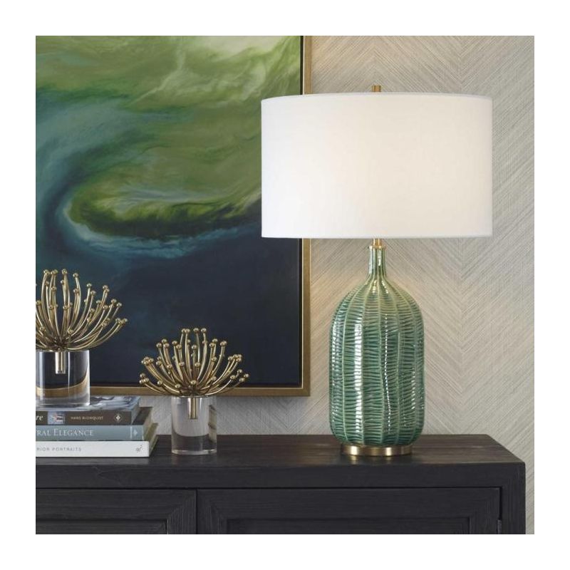 Table lamp with green glossy base and cream shade