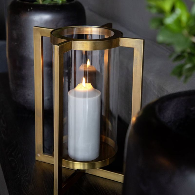 Large lantern with modern brass metal frame and glass candle holder