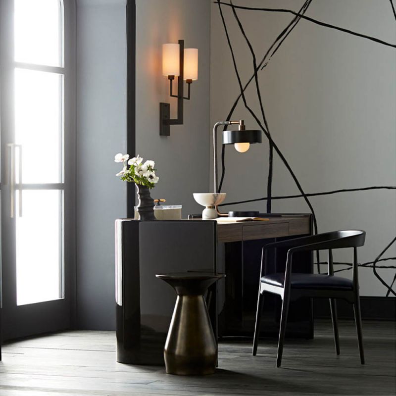 metallic side  table with a round top and tapered neck