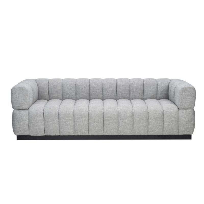 A luxury sofa by Liang & Eimil with a deep buttoned design and gorgeous grey upholstery