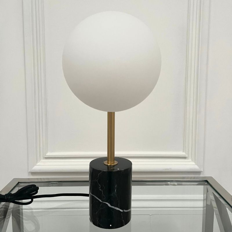 Brass table lamp with black marble base and matte opal frosted light 