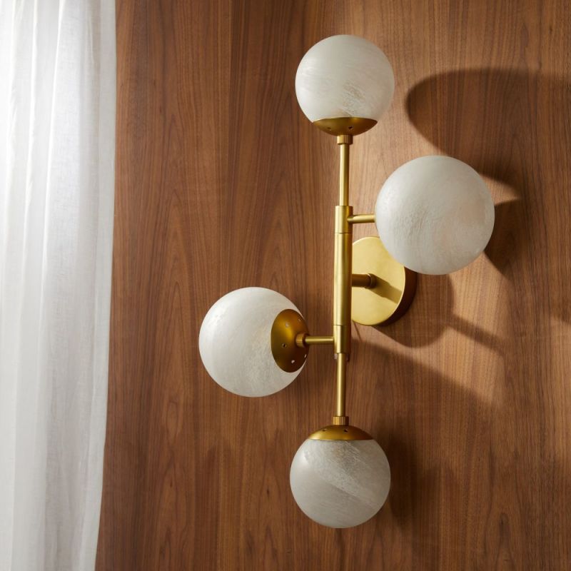 Wall sconce with four glass globes feature lights fitting in a gold frame