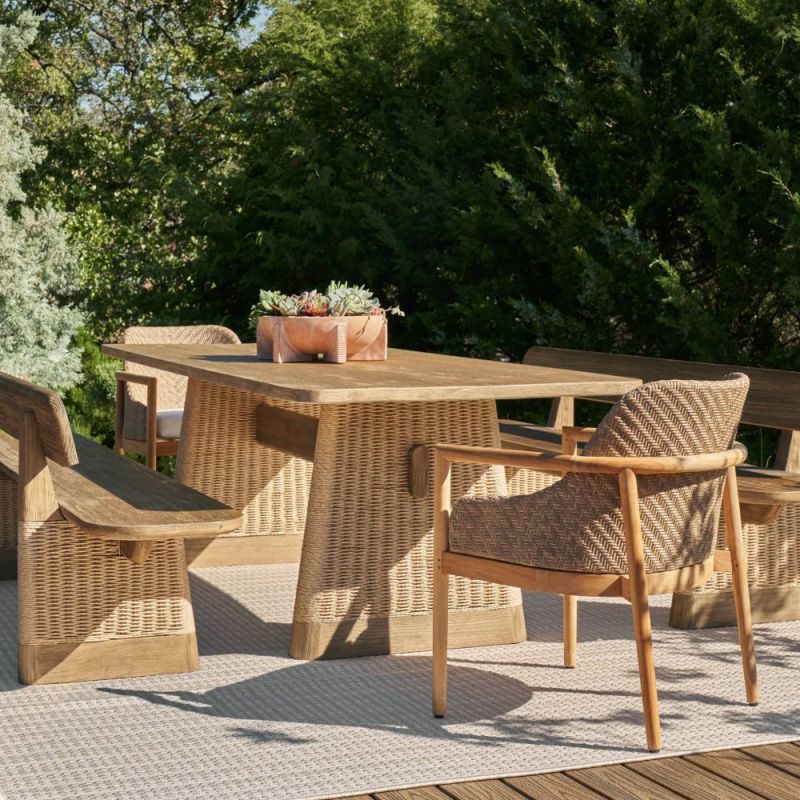 Rectangular teak dining table with two wide rattan legs and a supporting beam