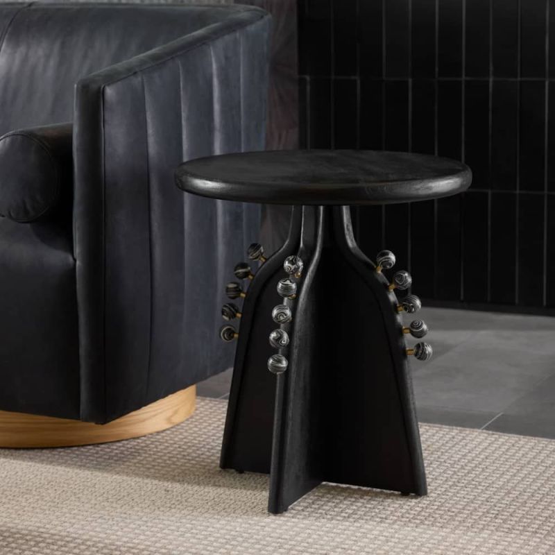 Black side table adorned with venus marbles