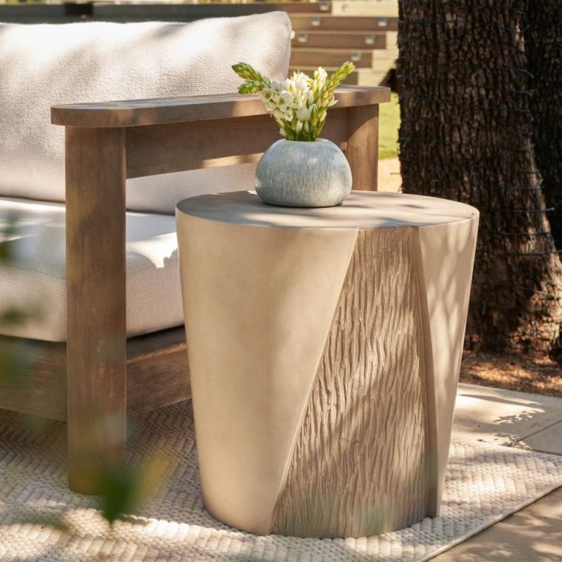 Concrete side table shaped to resemble a split tree trunk