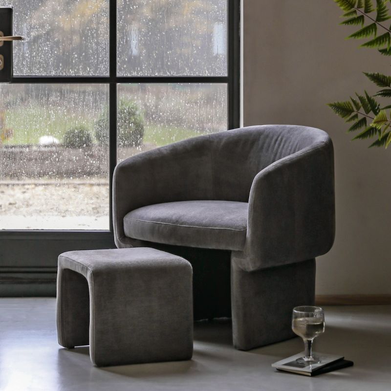  Curved armchair with squared footstool that slots underneath