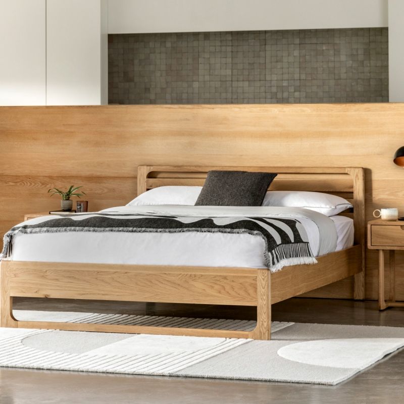 Stylish wooden kingsize bed with exposed corners