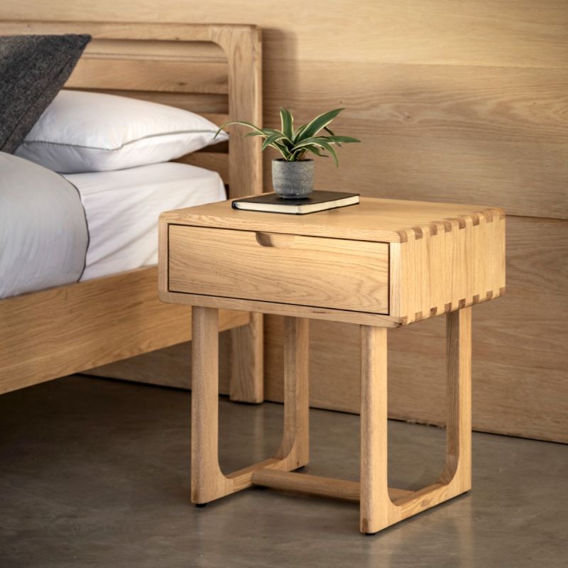 Stylish wooden bedside table with exposed corners