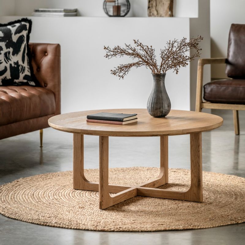 Round wooden coffee table with shaped underframe