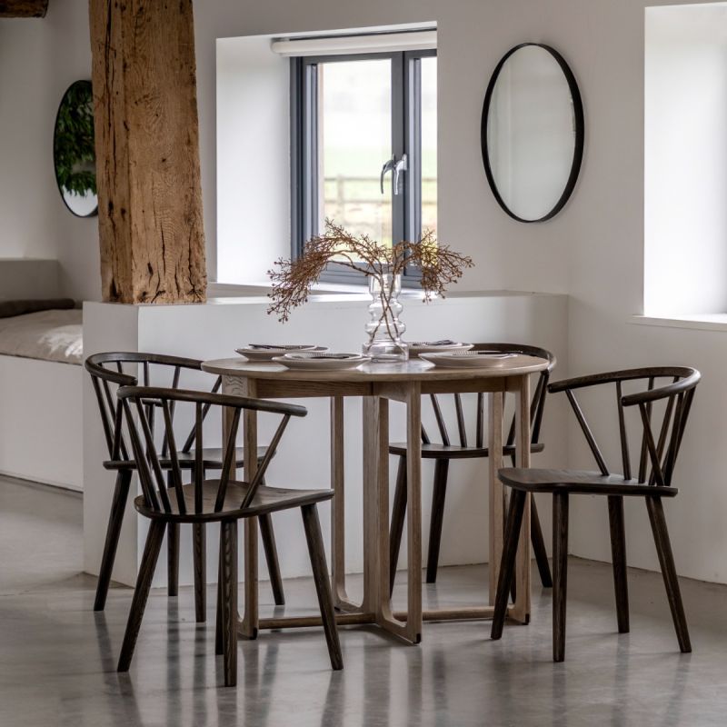 Folding circular wooden dining table with shaped underframe