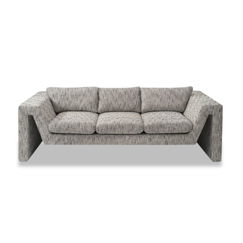 A stylish sofa by Liang & Eimil with an abstract shape and grey patterned upholstery