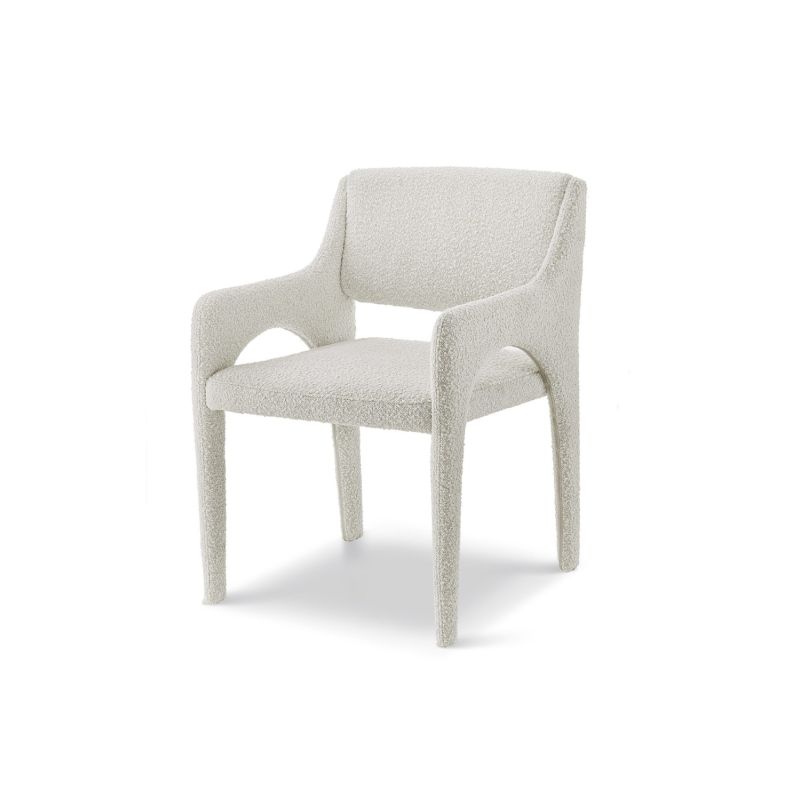 Elegant upholstered chair with arched supports and a complete fabric wrap in neutral boucle sand