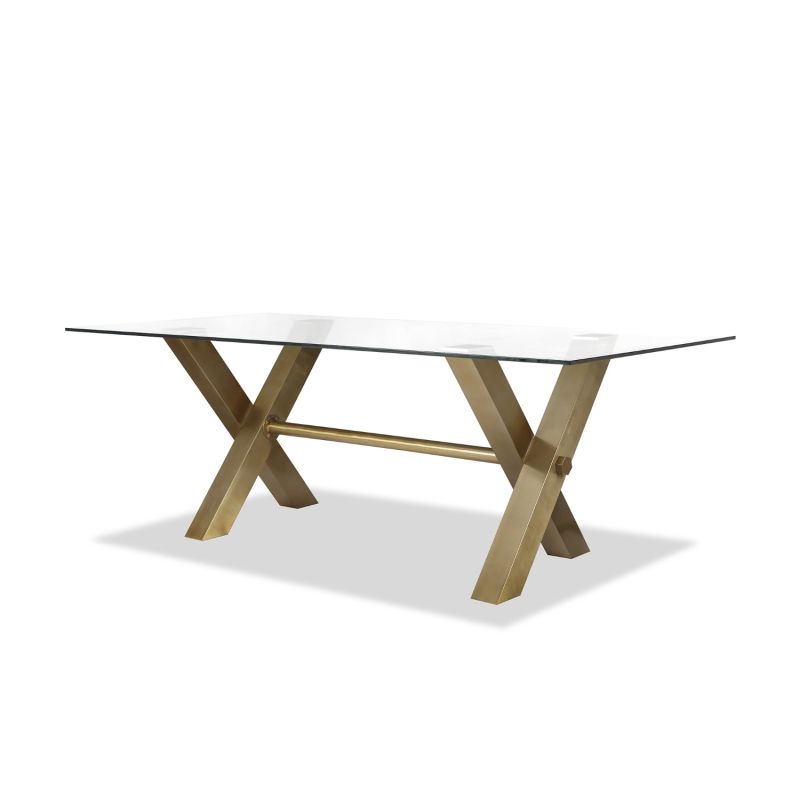 Artisan-crafted dining table with brass legs topped with an expanse of toughened clear glass