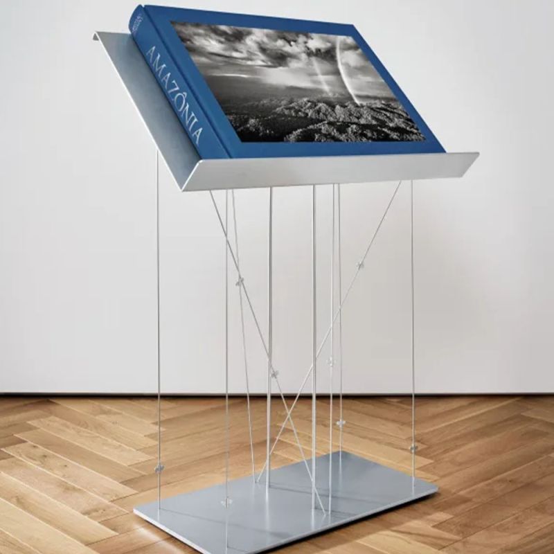 Sebastião Salgado's Collector’s Edition documents his six-year journey through the Brazilian Amazon, showcasing its unparalleled beauty and human connection, signed and numbered (No. 401–2,400) by Salgado, with a bookstand by Renzo Piano.