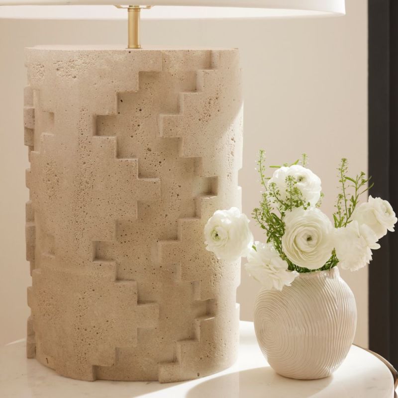 Geometric cut-out, travertine-style lamp with a cream shade