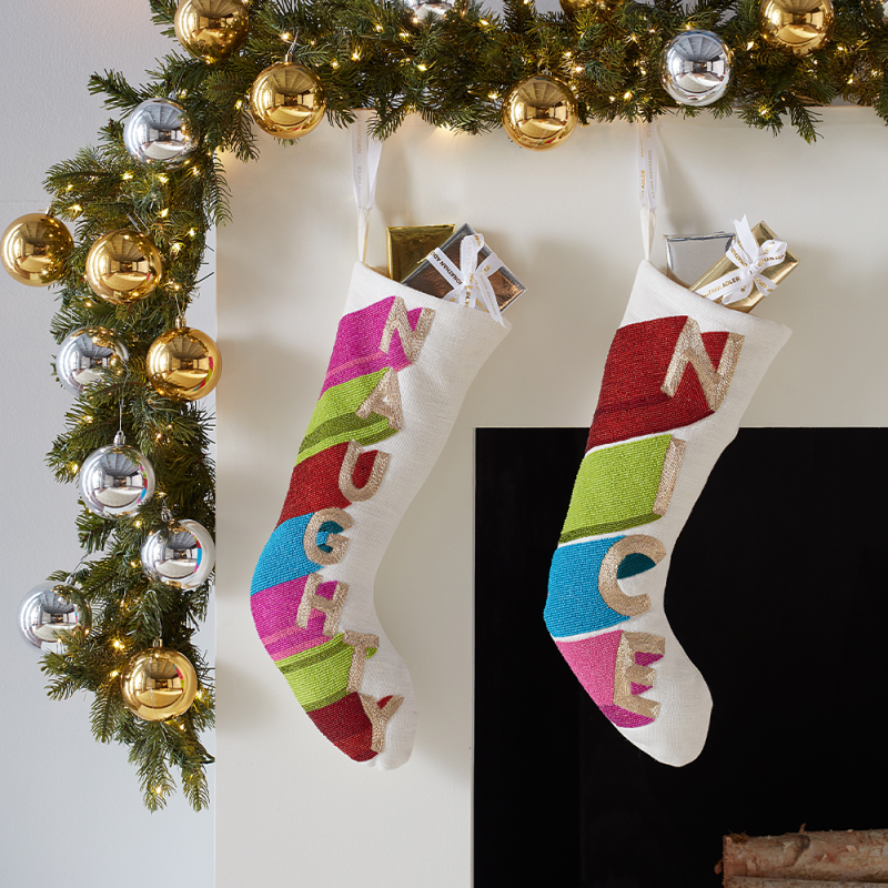 A bright and colourful hand beaded stocking with 'naughty'