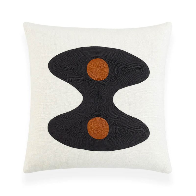 White cushion with black wavy shape and two orange circles