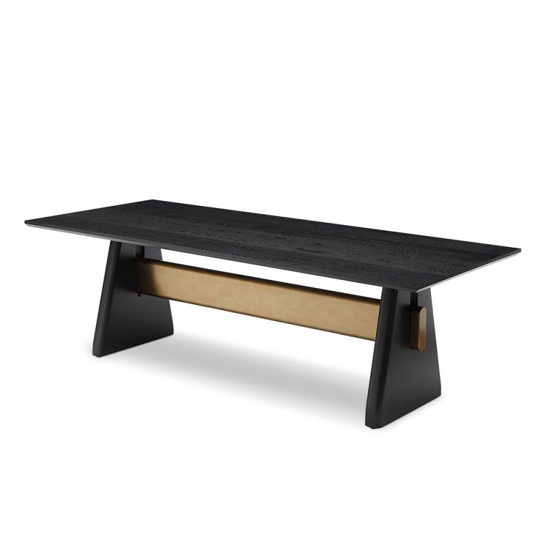 A statement dining table by Liang & Eimil with a black and brass finish