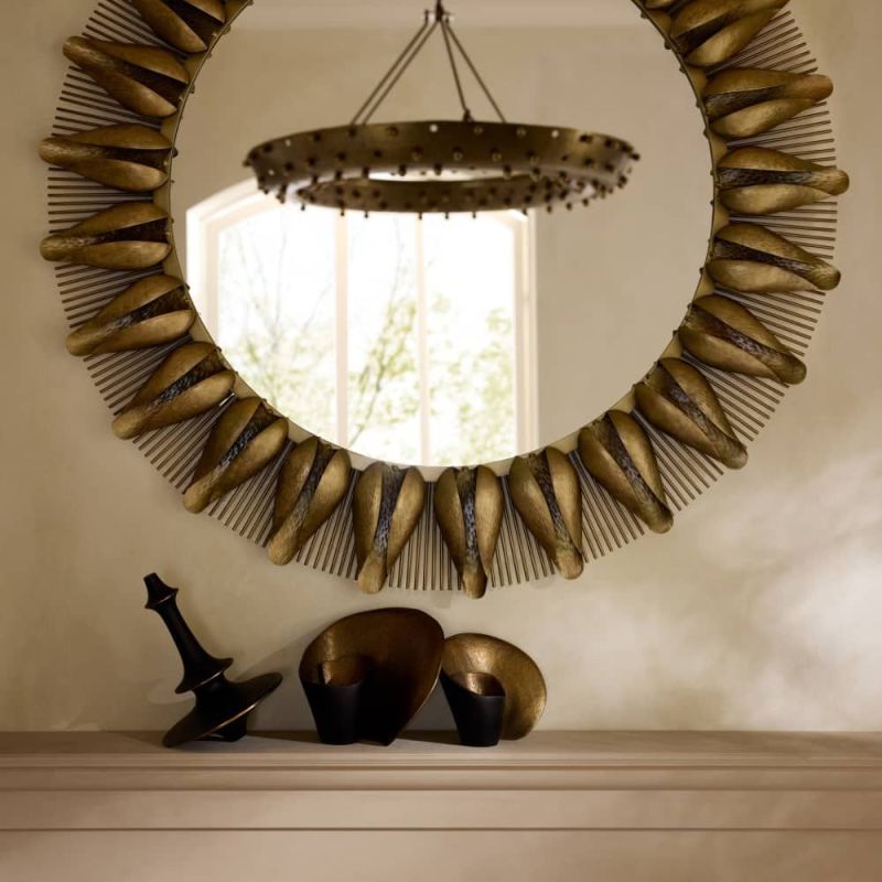 The Goldie Mirror reimagines mid-century style with lotus-like iron petals and sunburst rays plated in antique brass.