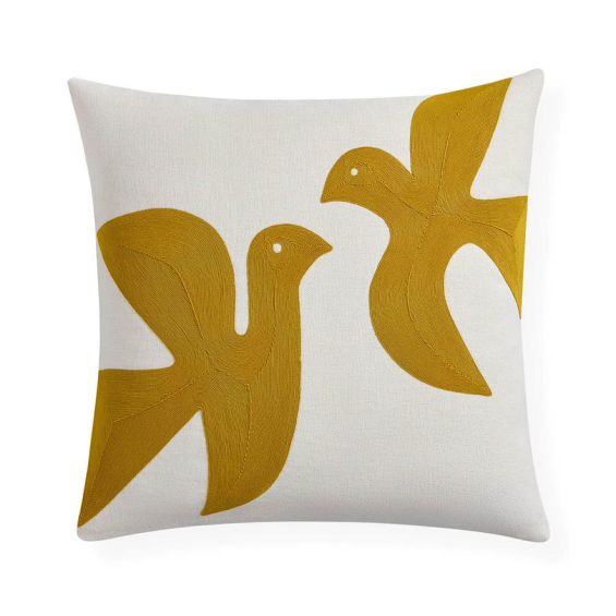 White cushion with yellow doves design 