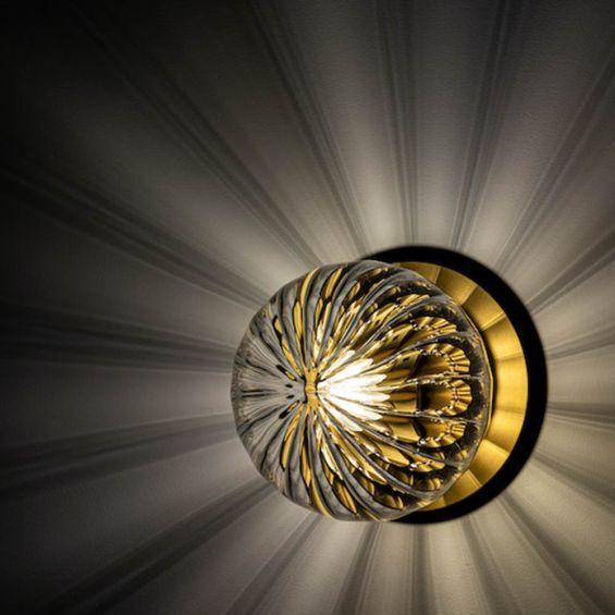 A stylish wall lamp by Schwung with a round, translucent glass shade and beautiful black gunmetal finish