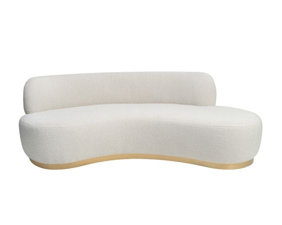 A contemporary sofa by Liang & Eimil with a curved design, beautiful boucle upholstery and brushed brass base