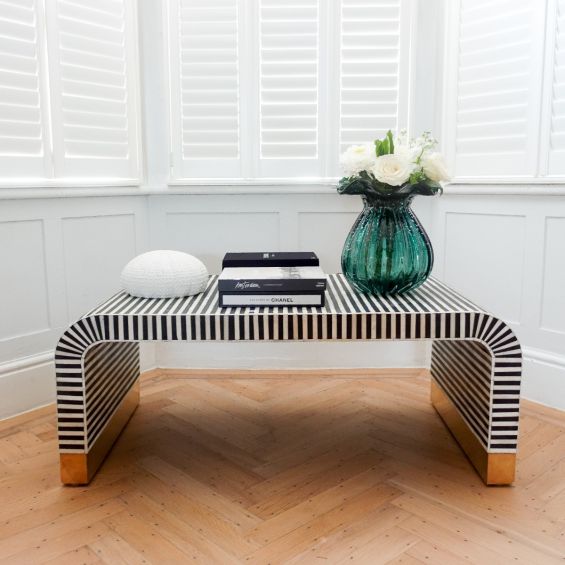 Striking black and bone inlay coffee table with elegant wooden feet