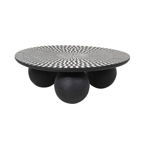 A stunning coffee table with a sunray design inlaid with bone and three statement spherical legs