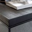 Rectangular coffee table with black metal legs and black wooden tabletop