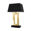 A luxurious golden table lamp with a black base and shade