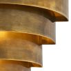 A statement wall lamp by Eichholtz with a vintage brass finish