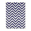 A bold blue and white reversible rug by Jonathan Adler with a zigzag pattern 