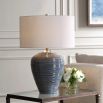 Table lamp with blue striped base in glossy finish with cream shade.