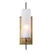 Cylindrical wall sconce mounted on brass panel base