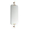 Wall mirror with rounded edges and brass wall fixtures at the top and bottom