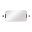 Wall mirror with rounded edges and brass wall fixtures at the top and bottom