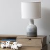 Ribbed, bottle shaped porcelain lamp with grey and off white ombre tones