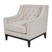 Sumptuous ivory coloured armchair with classic silhouette and deep buttoning on the back rest