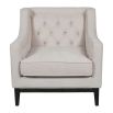 Sumptuous ivory coloured armchair with classic silhouette and deep buttoning on the back rest