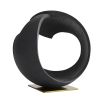 Round black stone sculpture on brass base