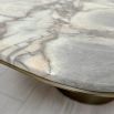 marble-topped table with brush brass base