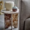 brown marble side table with three interlocking legs and round top