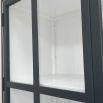 A sophisticated black display cabinet with tempered glass. A few scuffs and glue marks