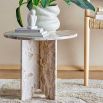 brown marble side table with three interlocking legs and round top