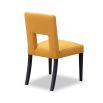 Dining chair with square cut out shape in backrest and luxurious mustard linen upholstery