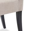 Beige dining chair with square cut out shape in backrest and luxurious linen upholstery