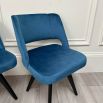 A glamorous Mid-Century dining chair with velvet upholstery and dark legs 